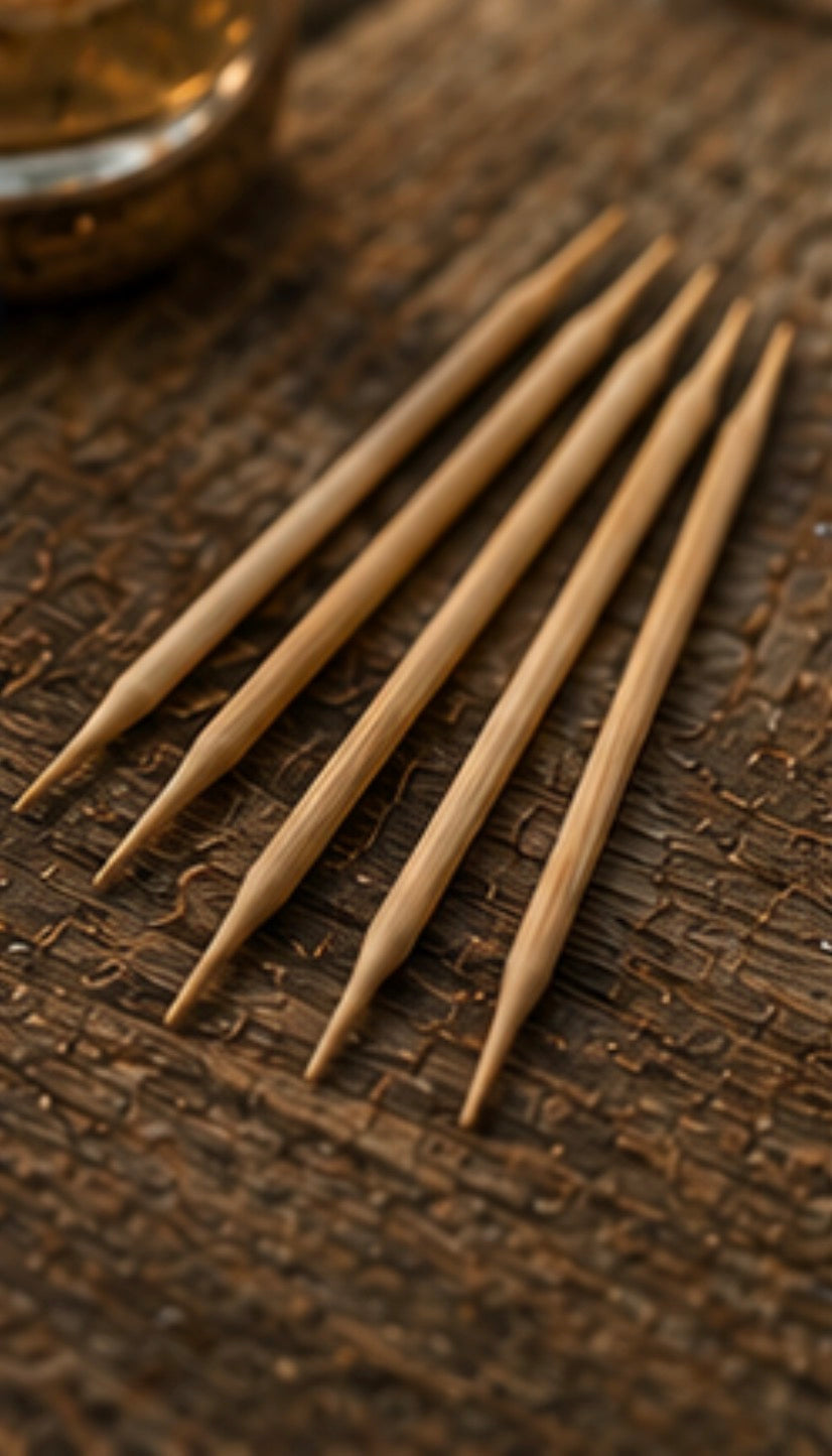 Set of wooden toothpicks on a textured brown surface