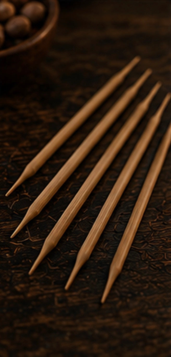 Set of wooden toothpicks on a dark textured surface