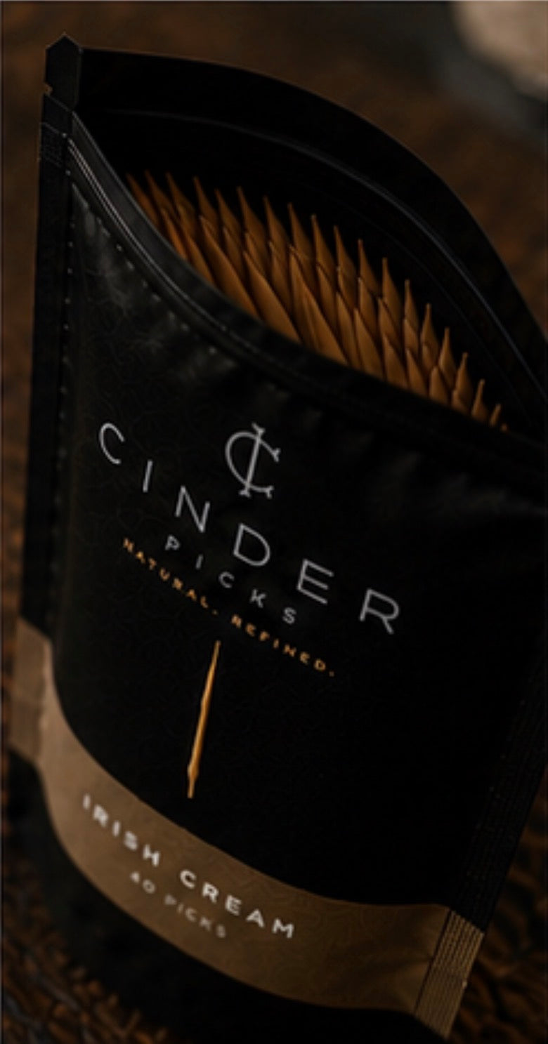 Pack of Cinder Picks Irish Cream flavor on a dark background