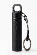 A black textured cylindrical Cinder Picks flavoured toothpick container with a loop handle on top, attached to a black lanyard and metal key ring, shown on a clean white background.