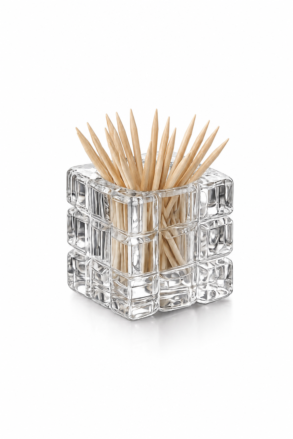 A clear glass cube-shaped toothpick holder filled with wooden toothpicks, photographed on a clean white background.