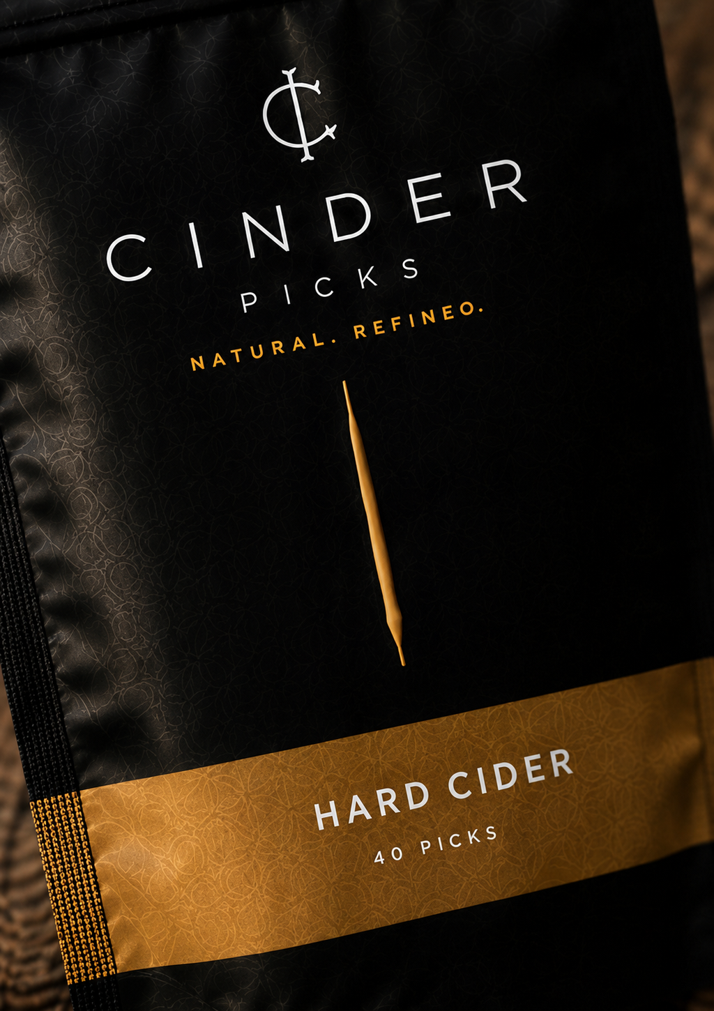 Cinder Picks hard cider packaging with black and gold design