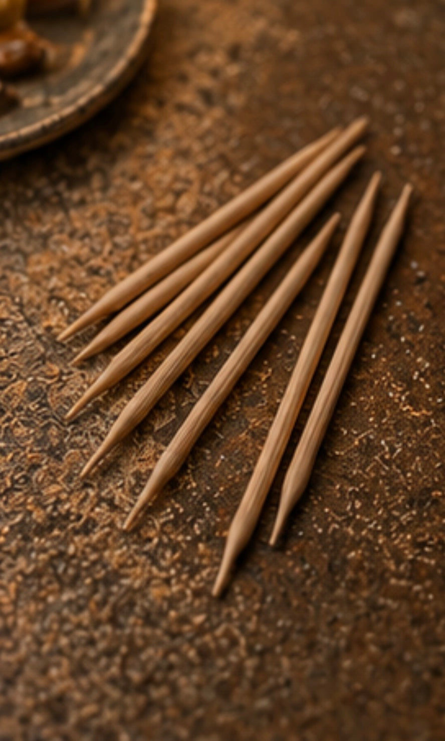 Set of birchwood Cinder Picks on a textured brown surface