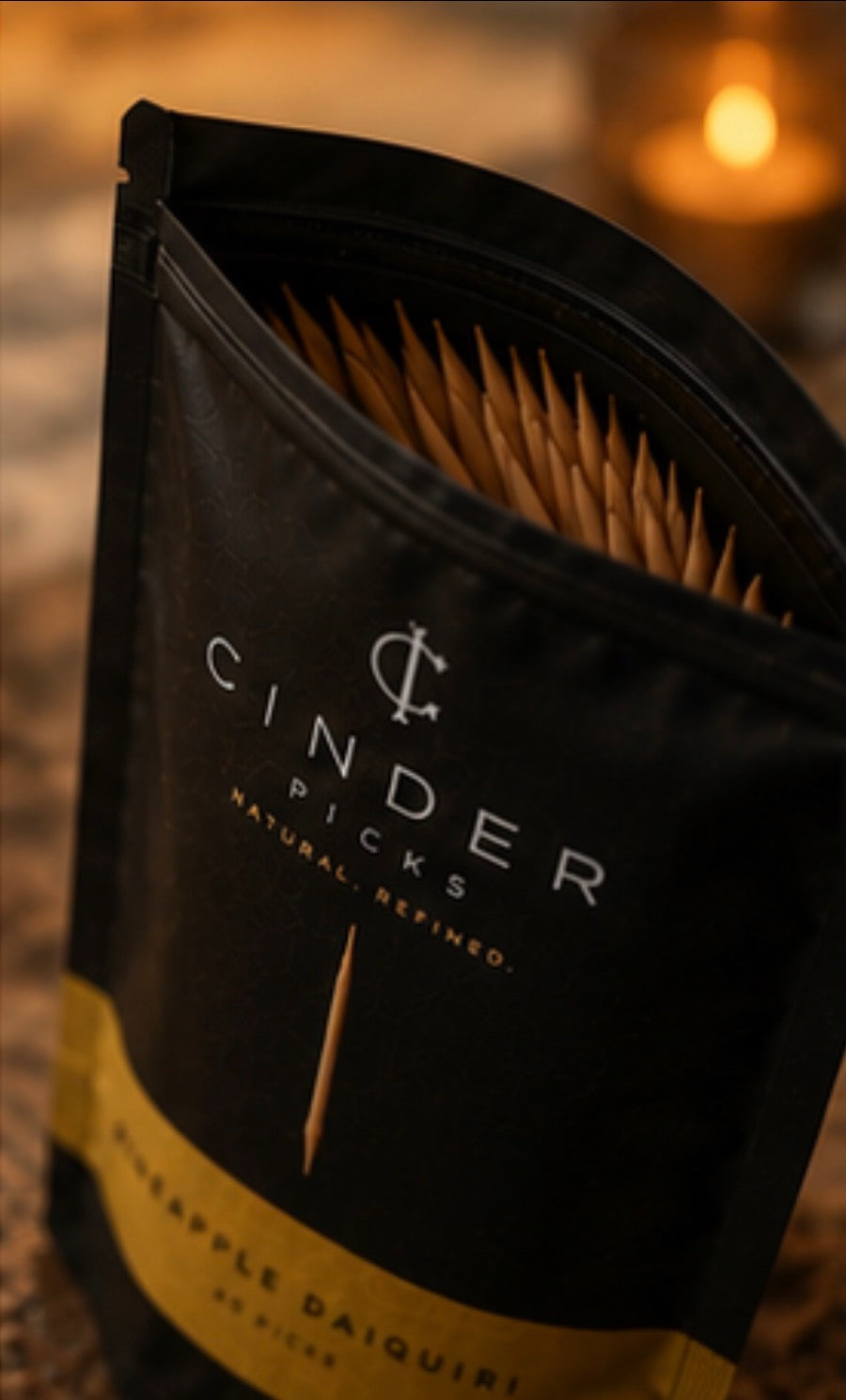 Pouch of Cinder Picks with brand name on a blurred background