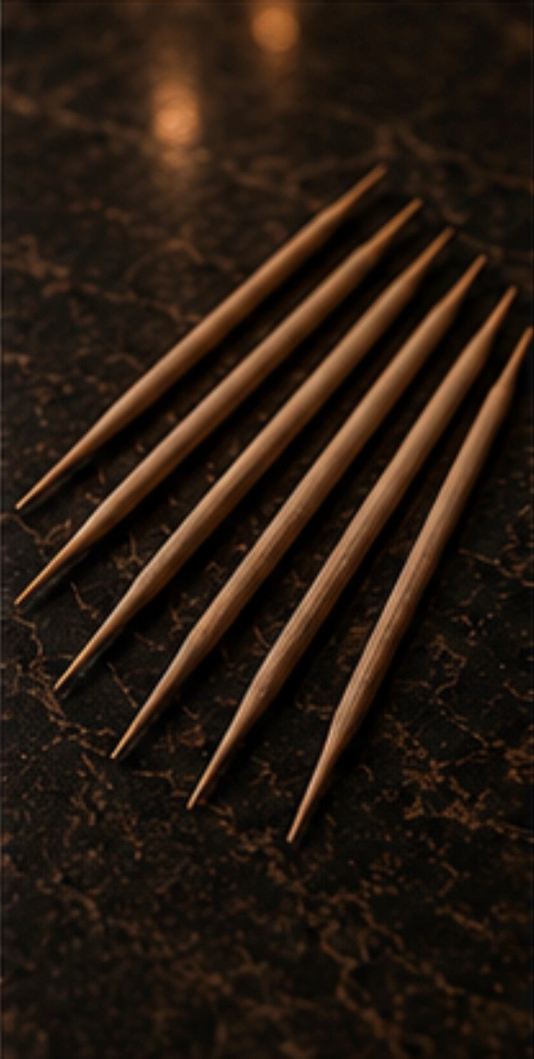 Set of birchwood Cinder Picks on a dark textured surface