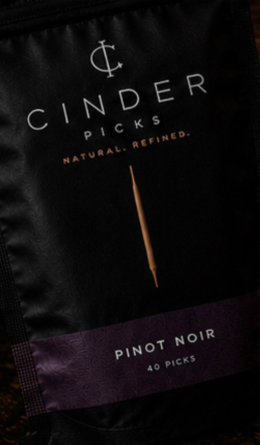 Cinder Picks packaging with a toothpick on a dark background