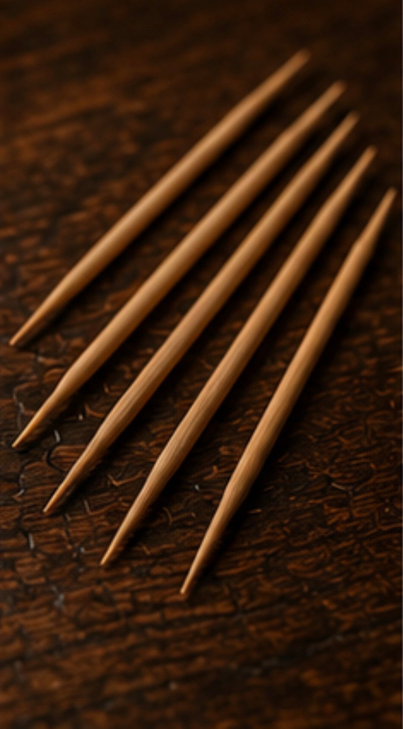 Set of birchwood Cinder Picks on a dark brown textured surface