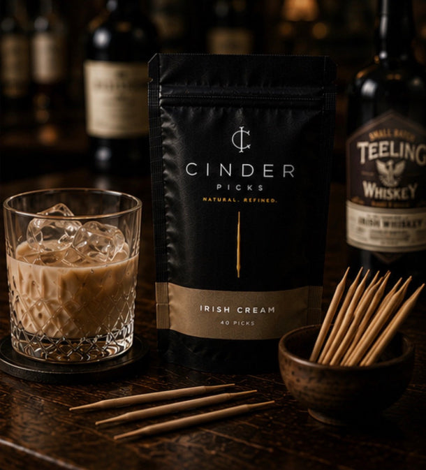 Cinder Picks Irish Cream flavour with a glass of iced Irish Cream on a bar.