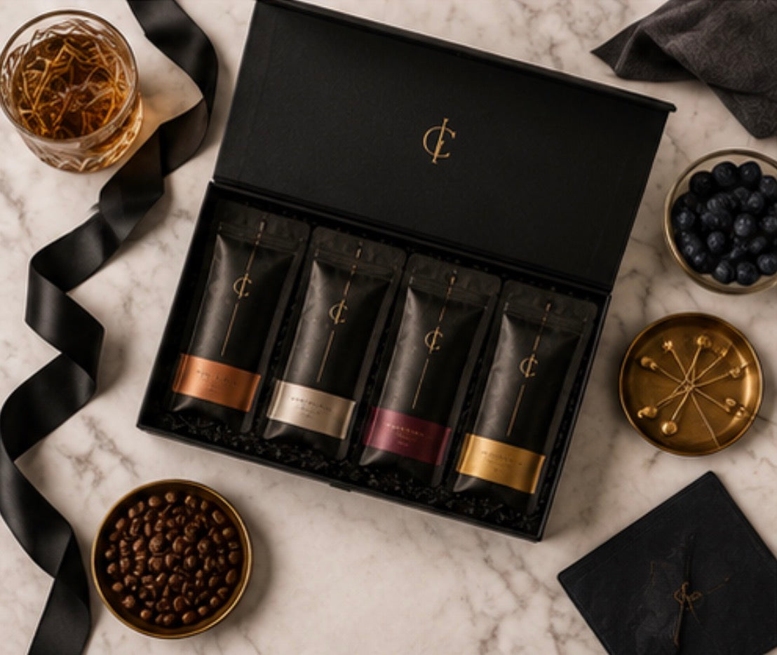 Set of Cinder Pick products in a box on a marble surface with decorative items.